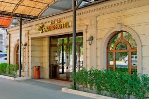 a building with a sign on the front of it at ATB Grand Hotel in Atyraū