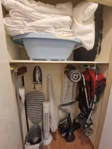a cupboard filled with lots of different items at Chez Anne WIFI dans le logement in Argentat