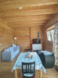 a dining room with a table in a log cabin at O Gato do Mar in Viana do Castelo