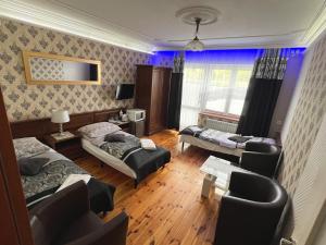 a hotel room with two beds and a living room at AbWentur Pokoje in Gdańsk +11 photos