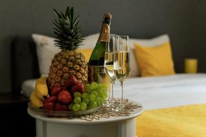 a tray of fruit and wine glasses on a table at Sunny Hotel in Lviv