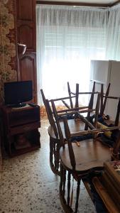 a room with two wooden chairs and a window at casa 1, 2 o 3 habitaciones - HOSTAL CAMELOT in Fabero