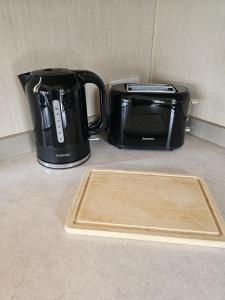 a coffee maker and a toaster on a counter at Punchbowl Caravan Park in Penrith +7 photos