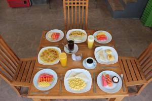 a wooden table with plates of food on it at nyoman sekumpul house in Sudaji +34 photos