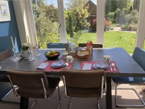 a dining room table with a bowl of fruit on it at Borough Lee in Midhurst