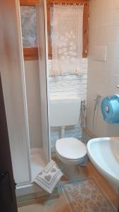 a small bathroom with a toilet and a sink at Benjamin Room in Olbia