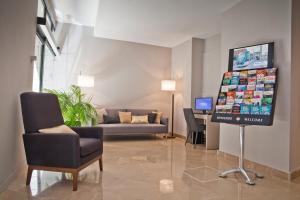 a living room with a tv and a couch at May Ramblas Hotel in Barcelona