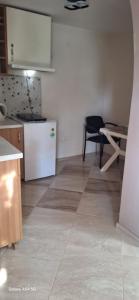 a kitchen with a white refrigerator and a table at Къща за гости ЕДЕЛВАЙС in Chernomorets +35 photos