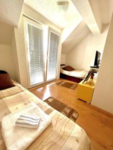 an attic bedroom with a bed and a window at A&M Apartments in Ohrid