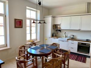 a kitchen with a dining room table and chairs at Hapsalutely Great residence - in full authenticity in Haapsalu