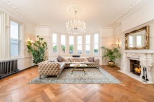 a living room with a couch and a fireplace at Luxury Villa - City Centre - Sleeps 13 in Nottingham