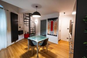 a dining room with a glass table and chairs at Dimora San Rocco in Molfetta
