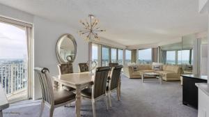 a dining room with a table and chairs and a couch at Residence 900 in Ocean City