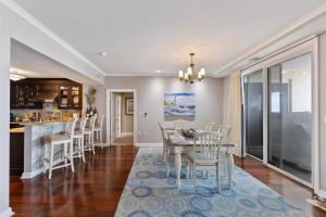 a dining room and kitchen with a table and chairs at Residence 409 At The Grand in Wildwood
