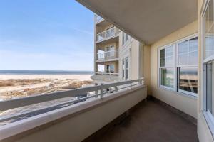 a balcony with windows and a view of the beach at Residence 409 At The Grand in Wildwood