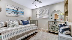 a bedroom with a bed and a mirror at 510 E 8Th Ave, Unit 101 in North Wildwood +7 photos
