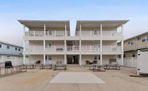 a large white building with tables in the courtyard at 5605 Seaview Ave, Unit G in Wildwood