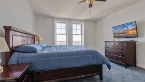 a bedroom with a bed and a dresser and a window at Residence 1205 At The Grand in Wildwood +28 photos