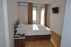 Postel nebo postele na pokoji v ubytování Merkez Otel