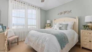 a white bedroom with a bed and a window at Residence 509 At The Grand in Wildwood +32 photos