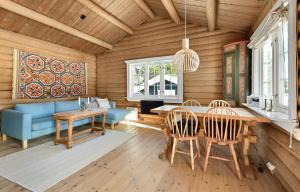 a dining room with a table and chairs at Atmospheric Log Cabin By Myllavannet 