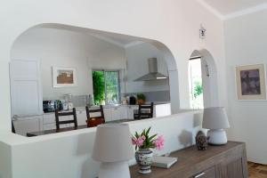 a kitchen with white walls and a table with two lamps at Beautiful private Villa with pool, Boliqueime, Loulé in Boliqueime