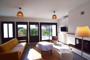 a living room with a couch and a table at Maison chaleureuse et lumineuse à la campagne proche Agen in Colayrac-Saint-Cirq