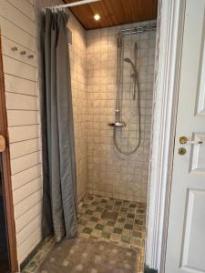 a bathroom with a shower with a shower curtain at Solkulla Matskog in Kulla