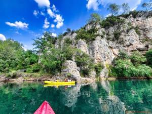 a kayak in the water next to a mountain at Ferme Saint-Georges en Provence in Le Val