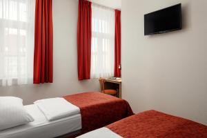 Postel nebo postele na pokoji v ubytování Hotel Ambiance
