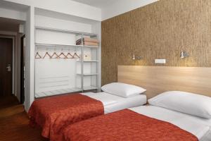Postel nebo postele na pokoji v ubytování Hotel Ambiance