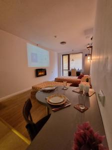 a living room with a table and a room with a couch at Mountain Paradise 2 - Quiet Cosy Studio - Balcony, Wifi in Bansko