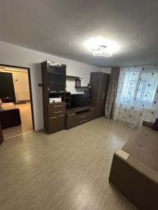 a living room with a couch and a flat screen tv at Anto Apartment in Piatra Neamţ