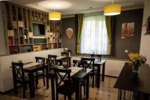 a dining room with tables and chairs and a window at Sunny Hotel in Lviv +29 photos