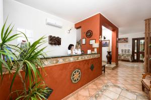 two women standing at a counter in a pharmacy at Sun Garden in San Vito lo Capo
