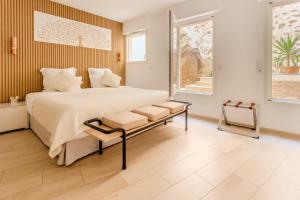 a bedroom with a large bed and a window at Hôtel Traverse Des Artistes in Cannes