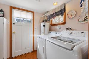 a laundry room with a white washer and dryer at 234 W 1St Ave in North Wildwood