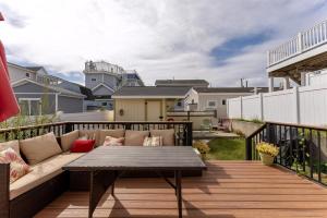 a patio with a couch and a table on a deck at 234 W 1St Ave in North Wildwood