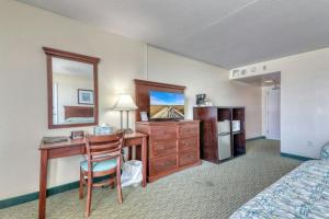 a hotel room with a desk and a bed at Blockade Runner in Myrtle Beach