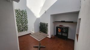 a empty hallway with a bench and plants on the wall at Buenavista in Ayamonte