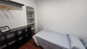 a bedroom with a bed and a dresser in a room at Buenavista in Ayamonte
