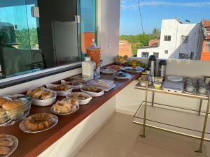 a buffet with many different types of food on it at Pousada Mineira in Barreirinhas