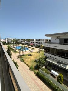 a view from the balcony of a building with a pool at Marbella beach el mansouria in Mansouria