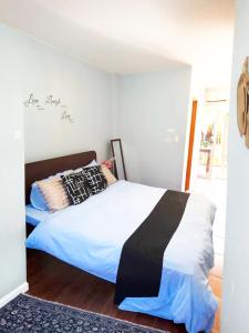 a bedroom with a bed with a black and white comforter at Maria's Inn Deluxe Room in Pooc