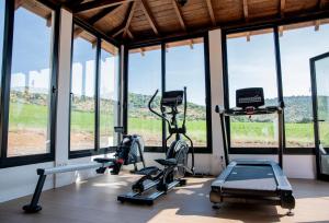 a gym with two exercise bikes and windows at Hotel Corbella in Posadas