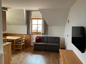 a living room with a couch and a table at Törggelehof Lana in Lana