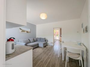 a living room with a couch and a table at Elegant Apartments BOP in Portorož +28 photos