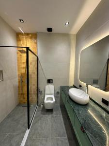 a bathroom with a toilet and a sink and a shower at Sea breeze PR2 in Nardaran