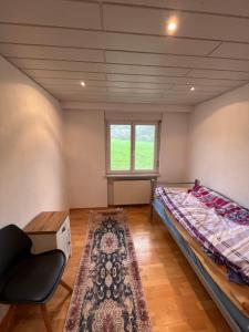a bedroom with a bed and a window and a rug at Monteurzimmer oder WG Zimmervermietung in traumhafter Lage in Laufenburg