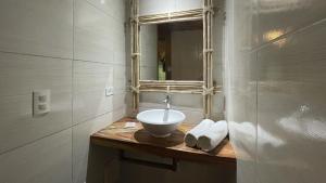 a bathroom with a sink and a mirror at Hotel Amazon by On Vacation in Leticia